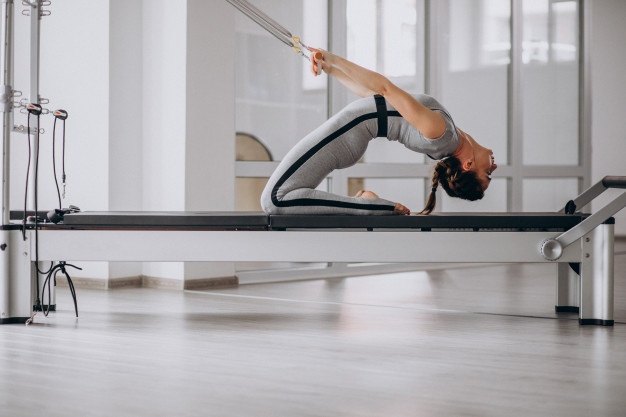 woman-practising-pilates-pilates-reformer_1303-14844